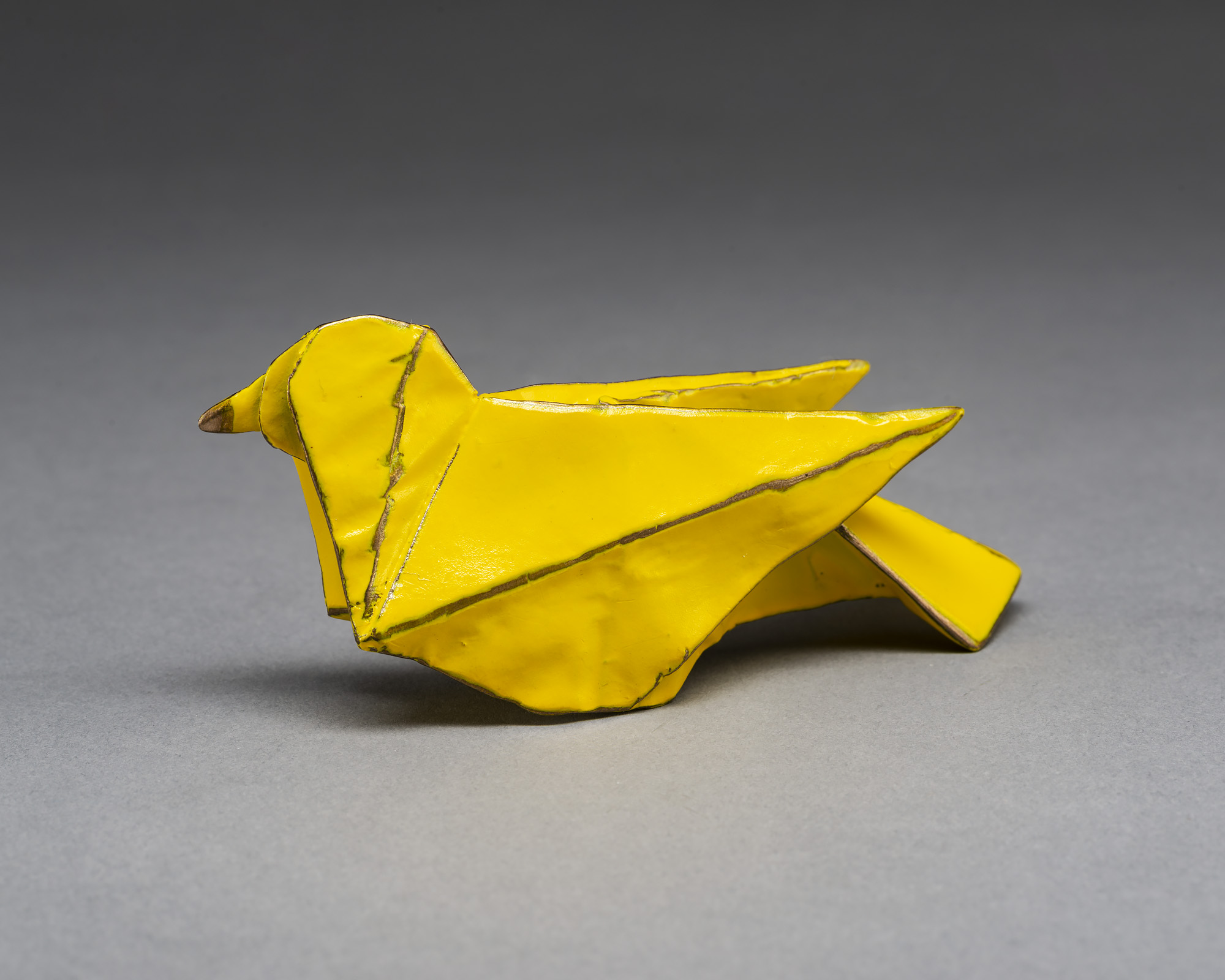Yellow origami bird sculpture